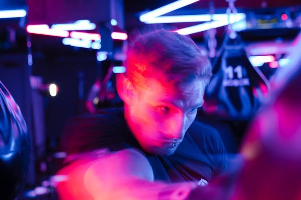 Person performing light cardio movements in a bright studio