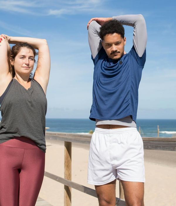 Young woman stretching outdoors during sunrise for energy boost